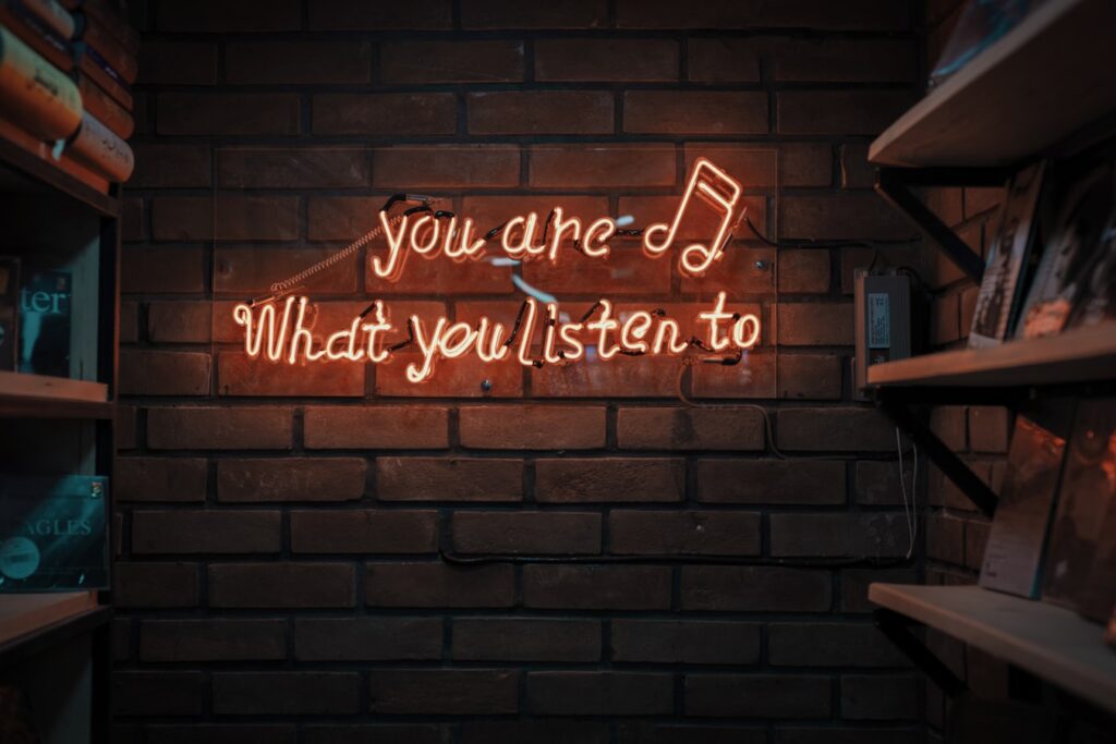 A neon sign with the words 'You are what you listen to'